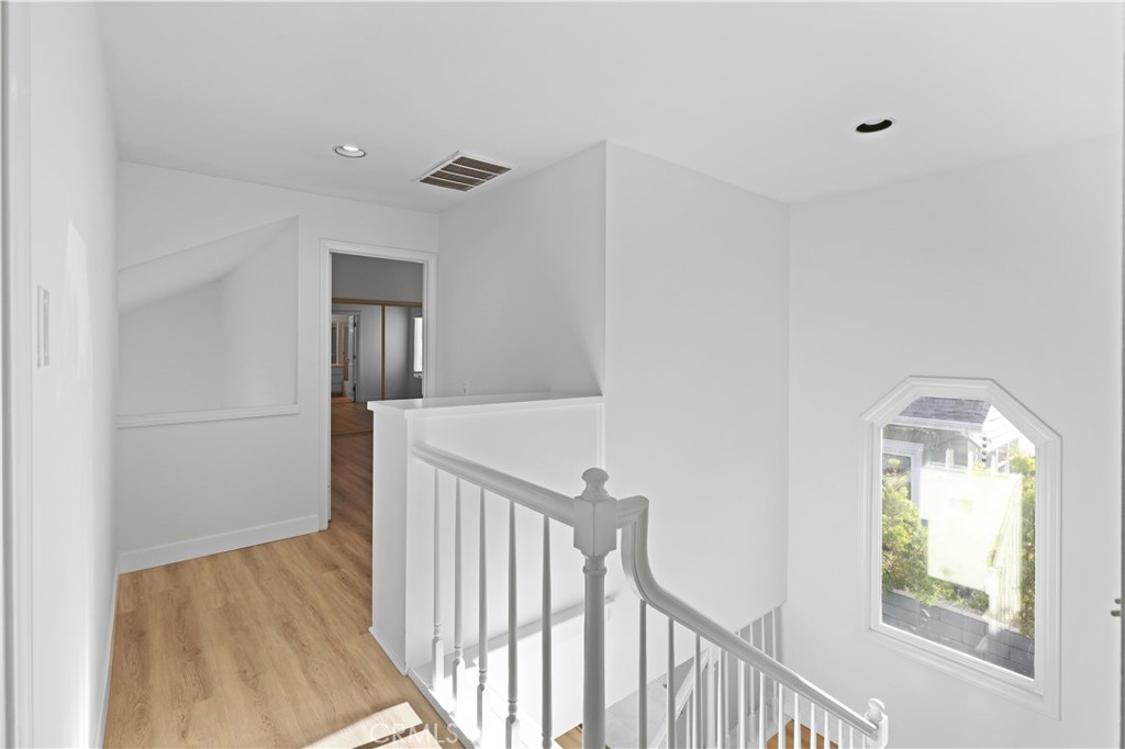 1597 Riverside Place Costa Mesa, CA 92627 - Photo 16 of 37 a view of a hallway with wooden floor and entryway