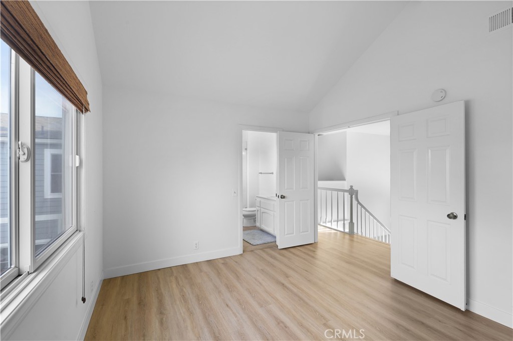 1597 Riverside Place Costa Mesa, CA 92627 - Photo 17 of 37 a view of empty room with wooden floor and white walls