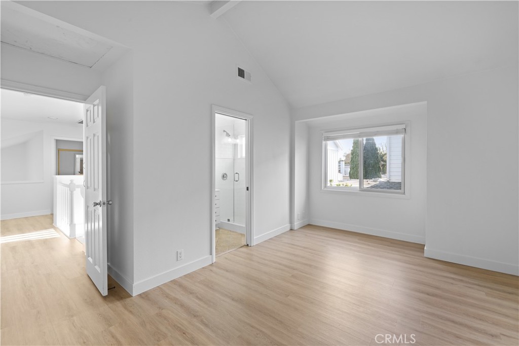 1597 Riverside Place Costa Mesa, CA 92627 - Photo 21 of 37 a view of an empty room with wooden floor and a window