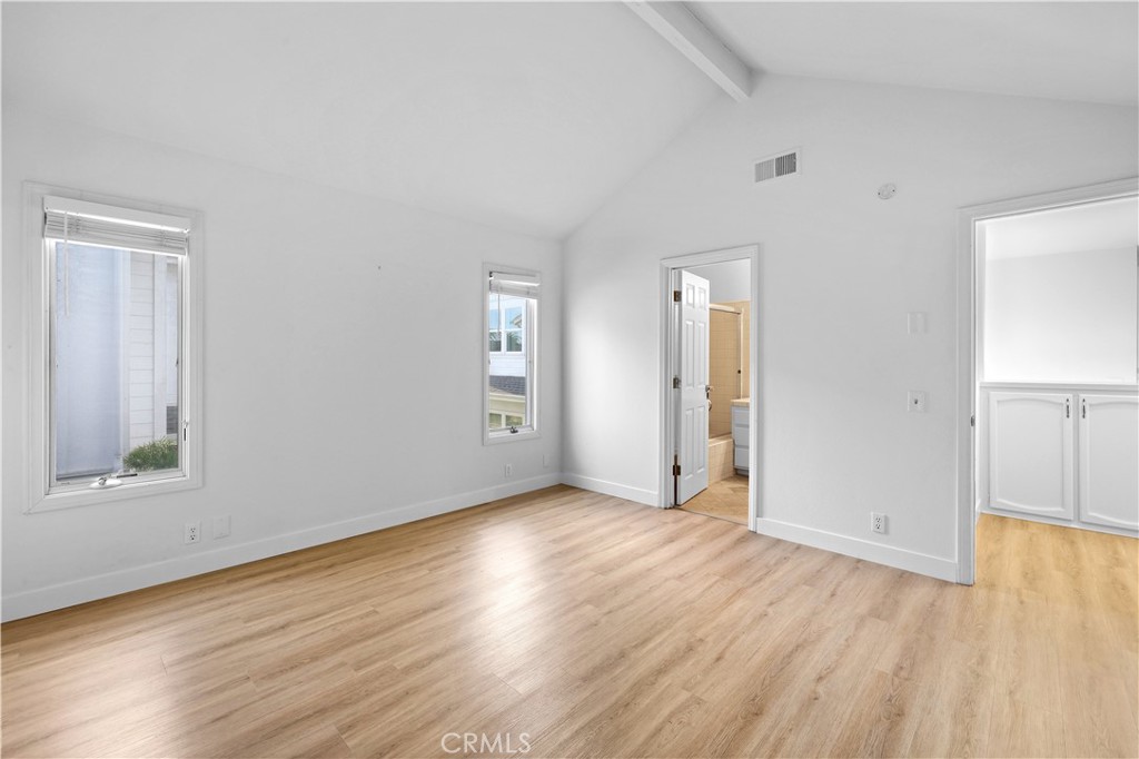 1597 Riverside Place Costa Mesa, CA 92627 - Photo 29 of 37 an empty room with wooden floor and windows