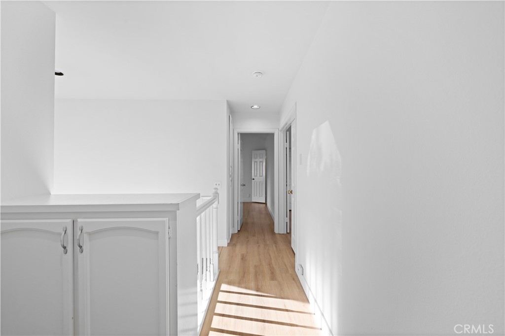 1597 Riverside Place Costa Mesa, CA 92627 - Photo 33 of 37 a view of a hallway with wooden floor