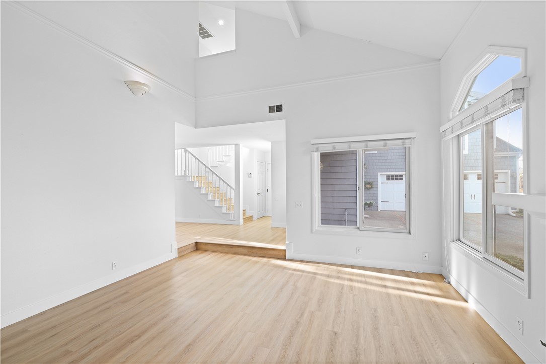 1597 Riverside Place Costa Mesa, CA 92627 - Photo 6 of 37 a view of an empty room with wooden floor and a window