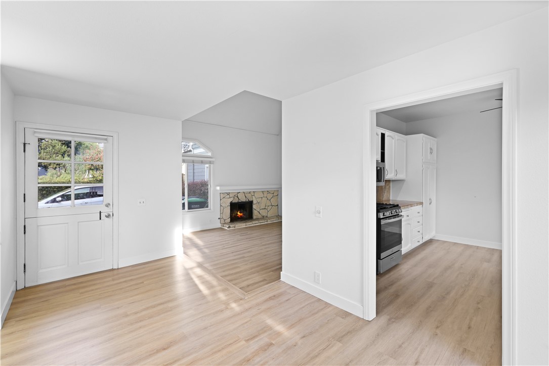 1597 Riverside Place Costa Mesa, CA 92627 - Photo 9 of 37 an empty room with wooden floor and windows