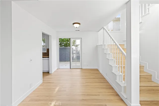 a view of an entryway with wooden floor