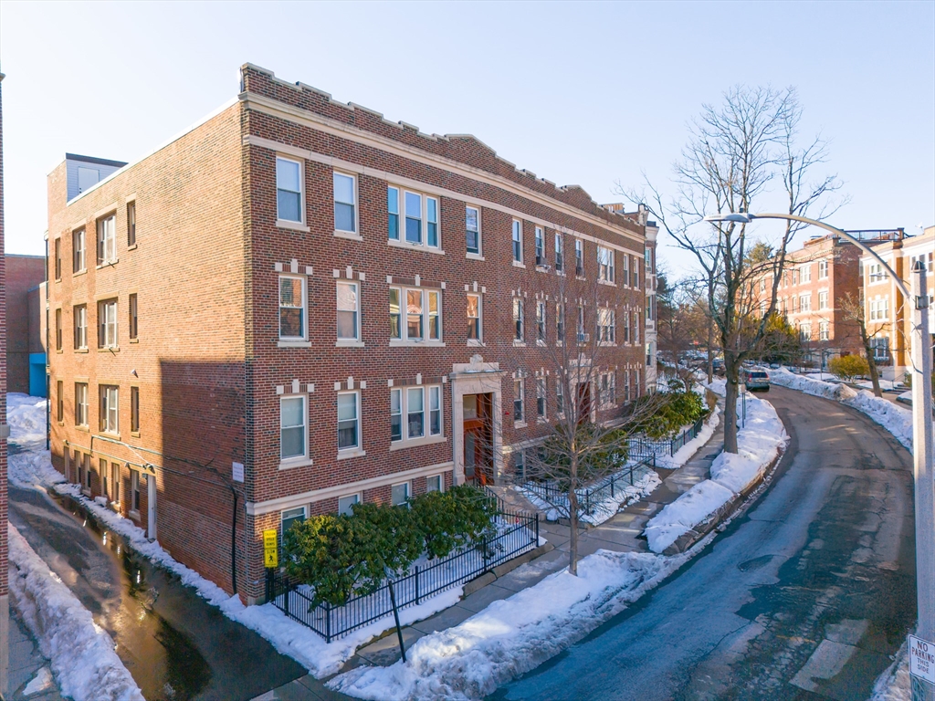 14 James Street, Unit 3 Brookline, MA 02446 - Photo 11 of 12 a view of a brick building next to a yard