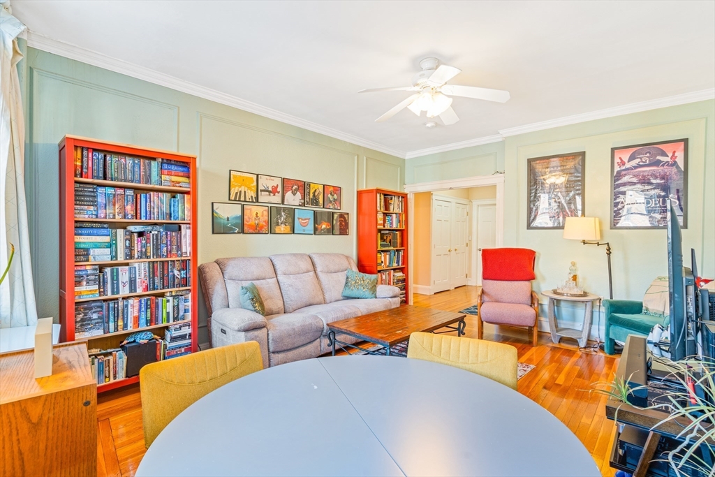 14 James Street, Unit 3 Brookline, MA 02446 - Photo 2 of 12 a living room with furniture a bookshelf and a window