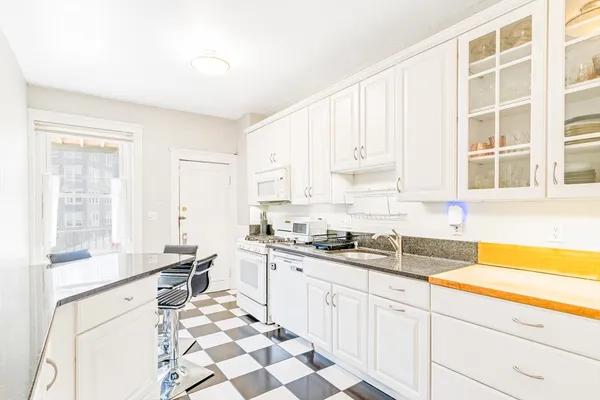a kitchen with a sink stove and cabinets