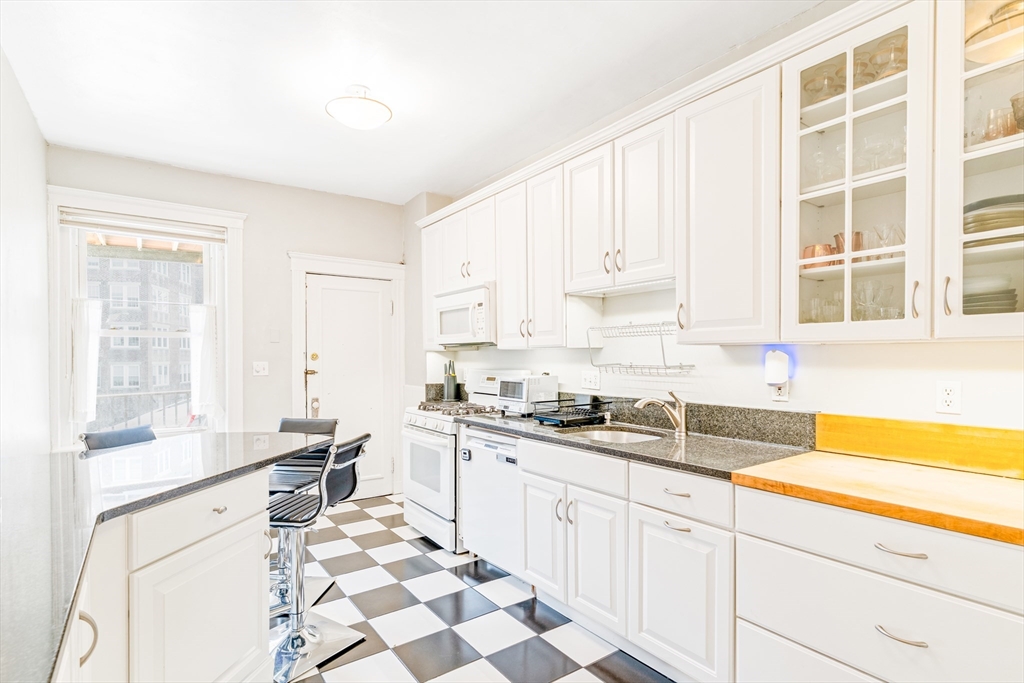 14 James Street, Unit 3 Brookline, MA 02446 - Photo 3 of 12 a kitchen with a sink stove and cabinets