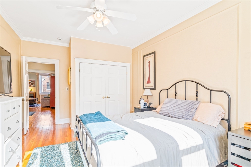 14 James Street, Unit 3 Brookline, MA 02446 - Photo 5 of 12 a bedroom with a bed and a chandelier