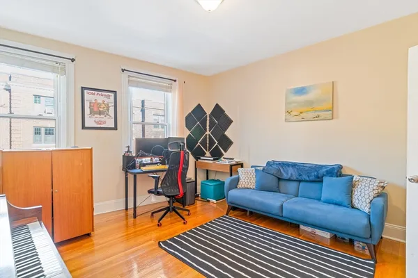 a living room with furniture a rug and a wooden floor