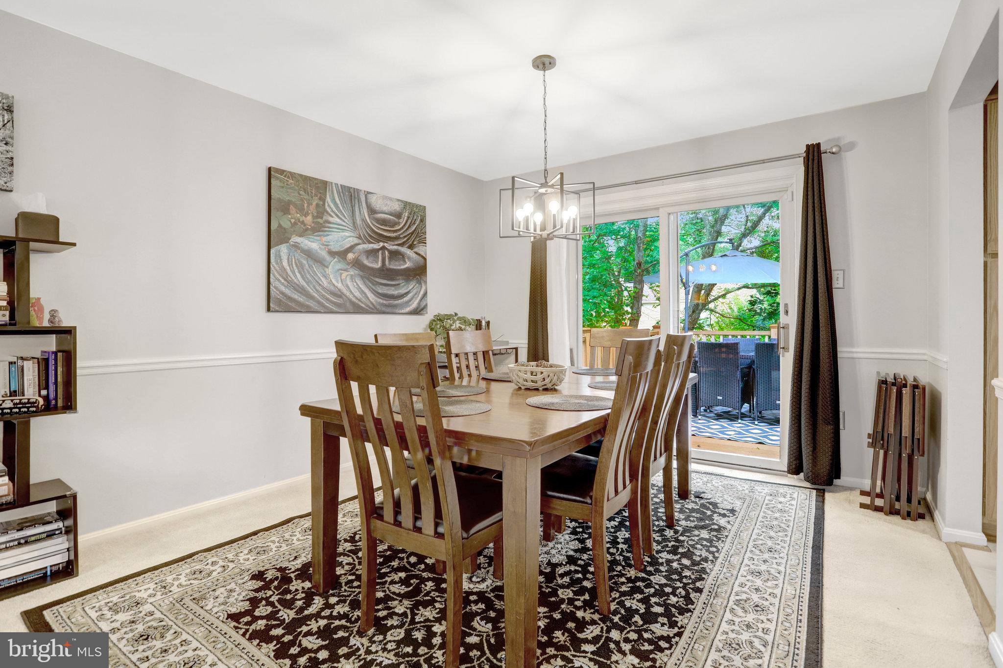 4518 Flintstone Road Alexandria, VA 22306 - Photo 13 of 62 a dining room with furniture a chandelier and window