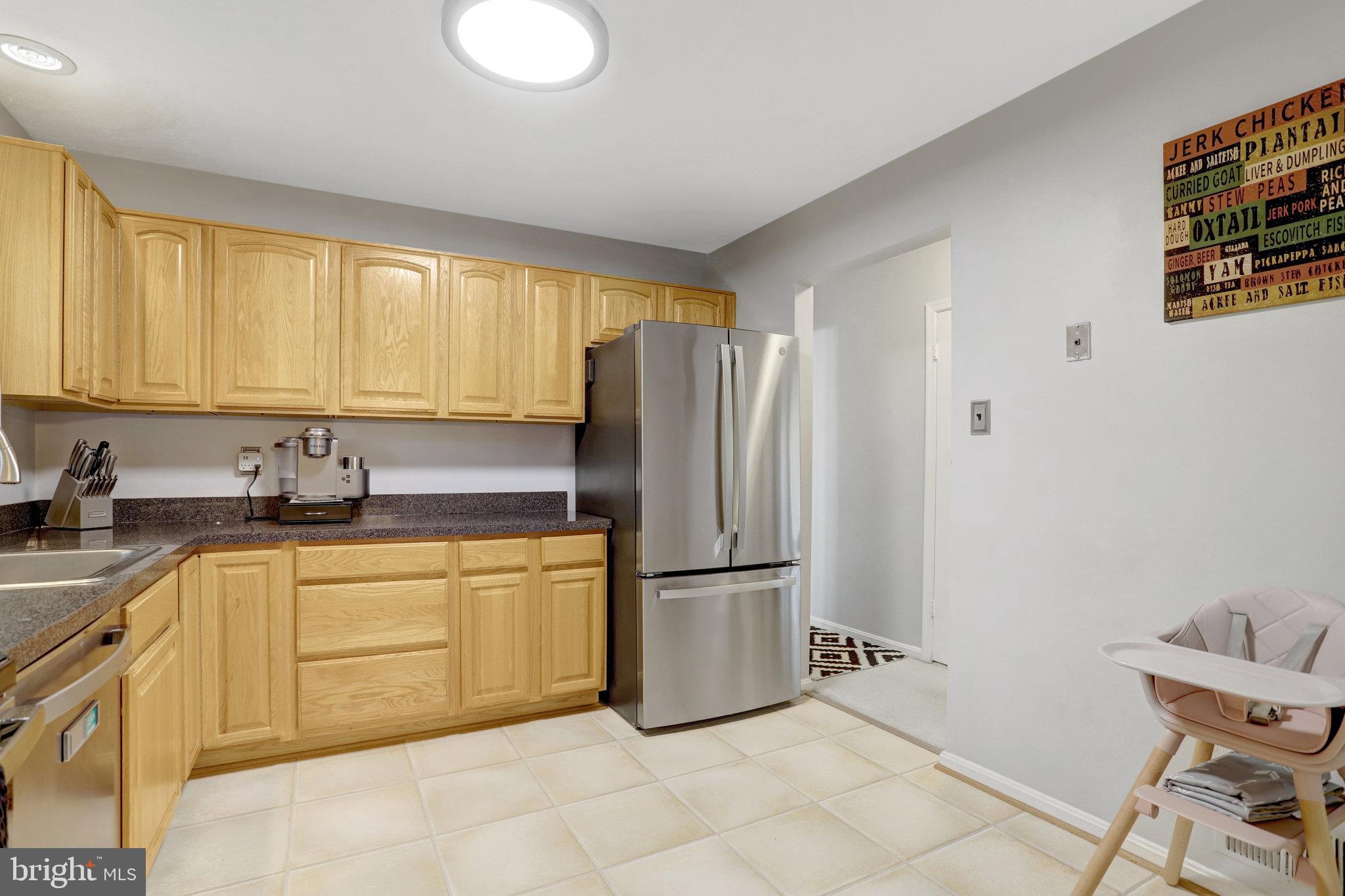 4518 Flintstone Road Alexandria, VA 22306 - Photo 18 of 62 a kitchen with stainless steel appliances granite countertop a refrigerator sink and cabinets