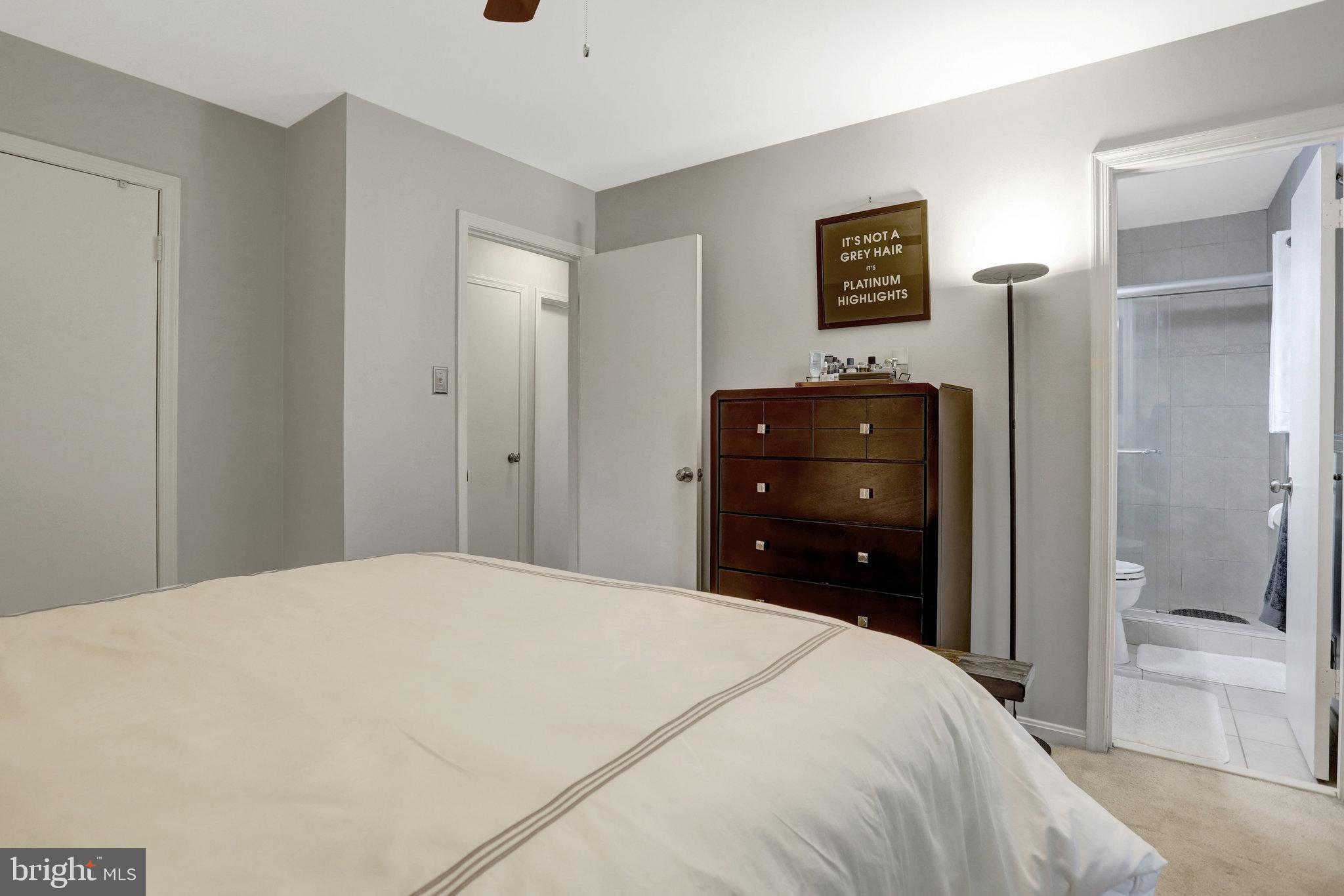 4518 Flintstone Road Alexandria, VA 22306 - Photo 25 of 62 a bedroom with a bed and a lamp on dresser