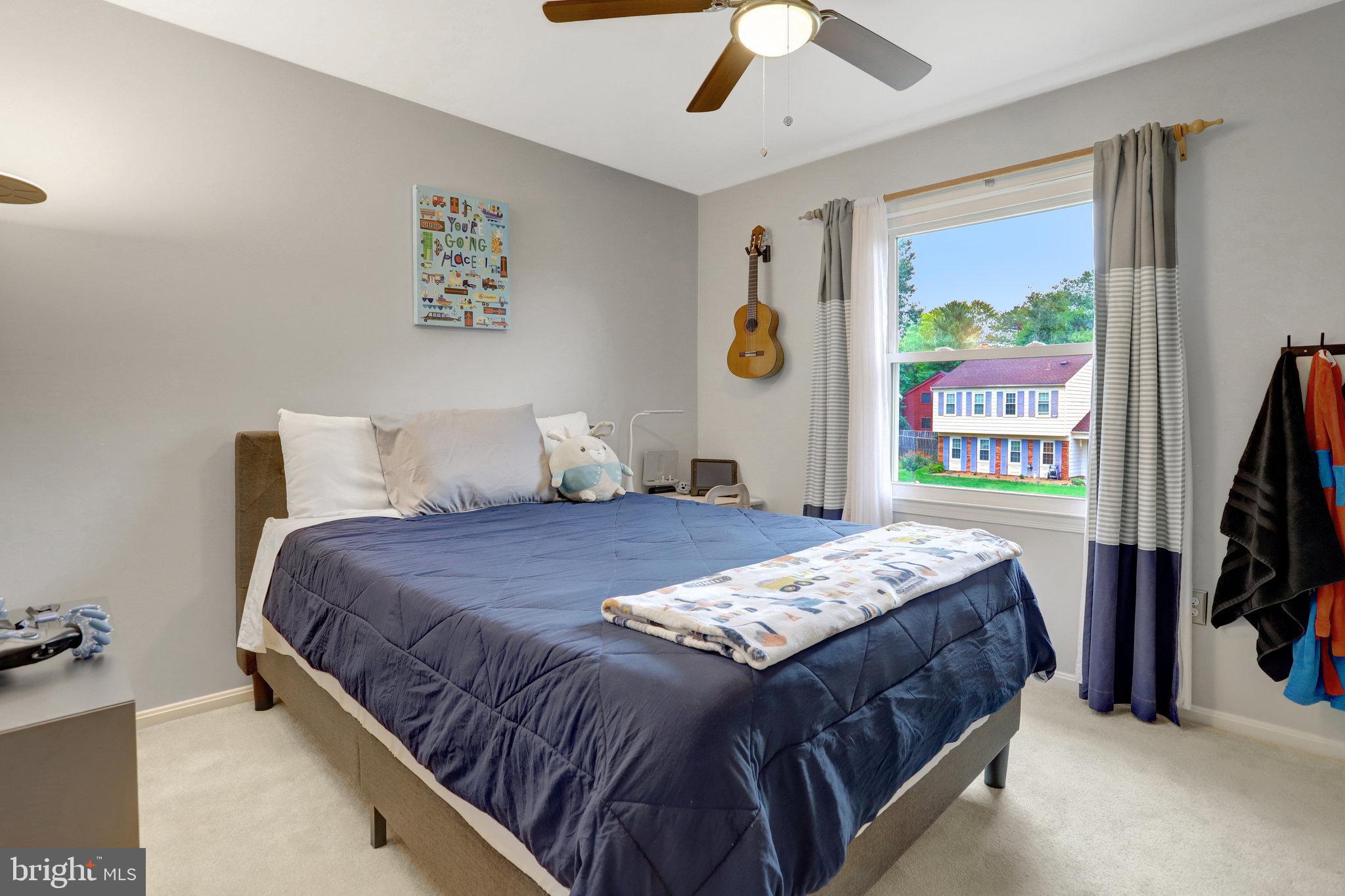 4518 Flintstone Road Alexandria, VA 22306 - Photo 28 of 62 a bedroom with a bed and a flat screen tv