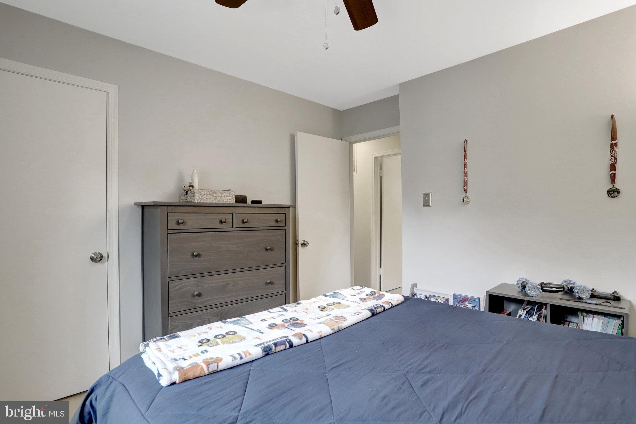 4518 Flintstone Road Alexandria, VA 22306 - Photo 31 of 62 a bedroom with a bed and a dresser in it