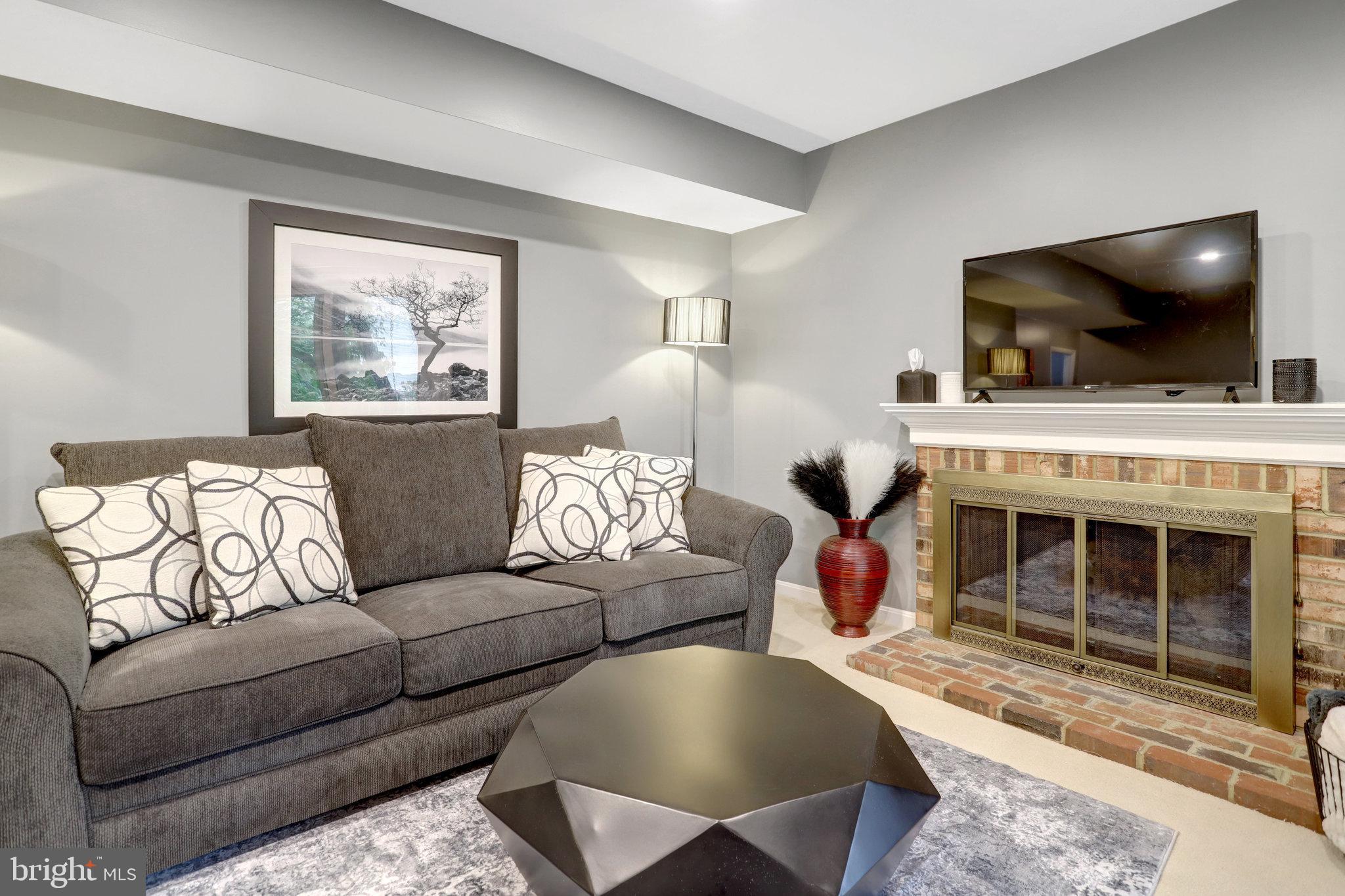 4518 Flintstone Road Alexandria, VA 22306 - Photo 40 of 62 a living room with furniture and a flat screen tv