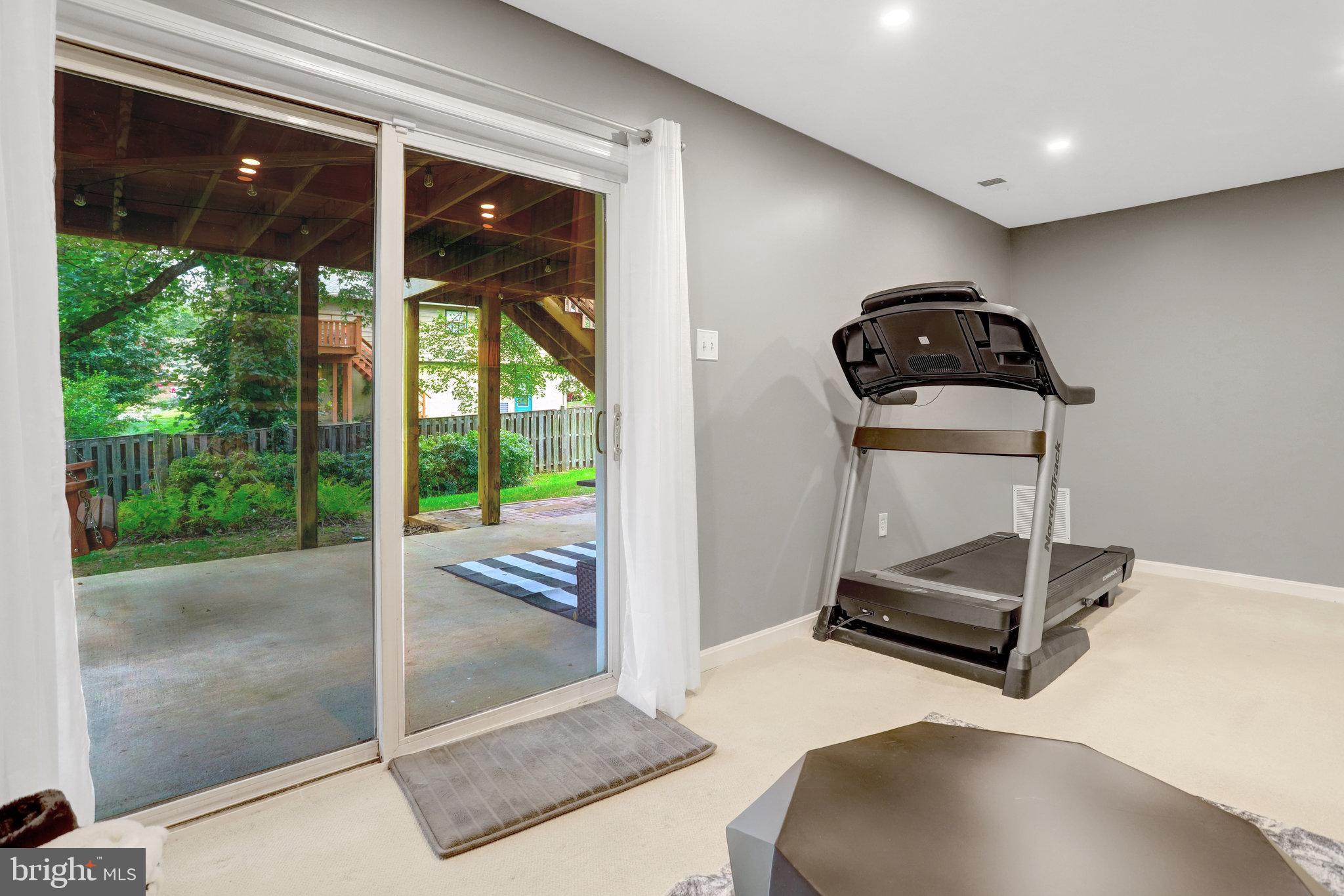 4518 Flintstone Road Alexandria, VA 22306 - Photo 41 of 62 a room with gym equipment and floor to ceiling window