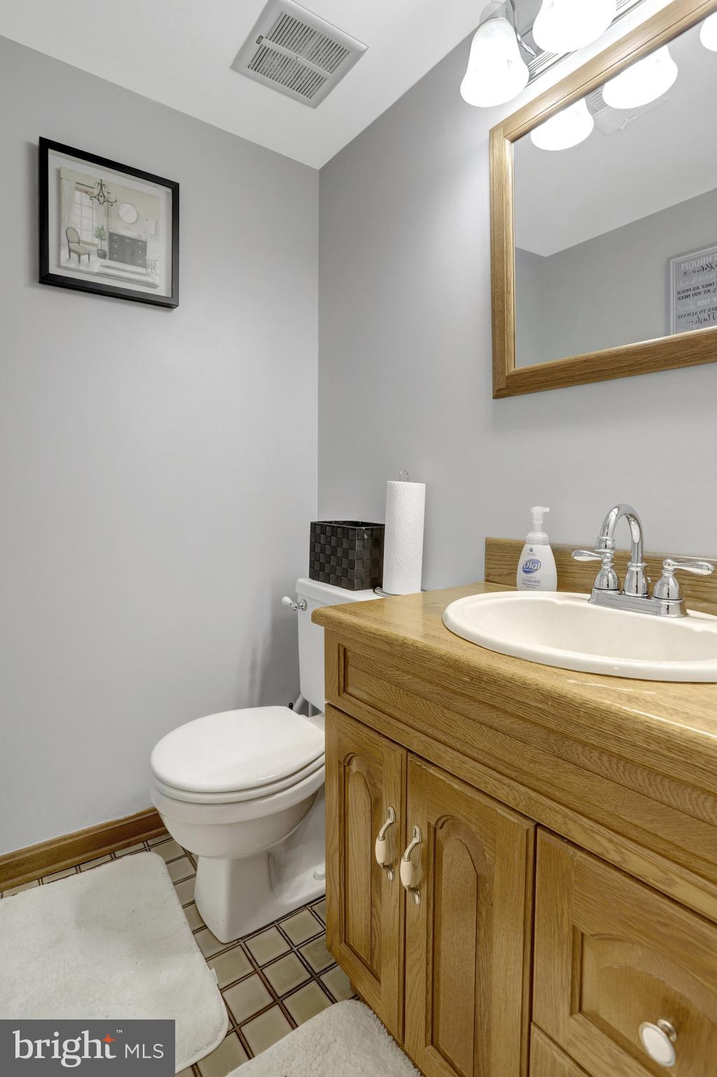 4518 Flintstone Road Alexandria, VA 22306 - Photo 51 of 62 a bathroom with a granite countertop toilet sink and mirror