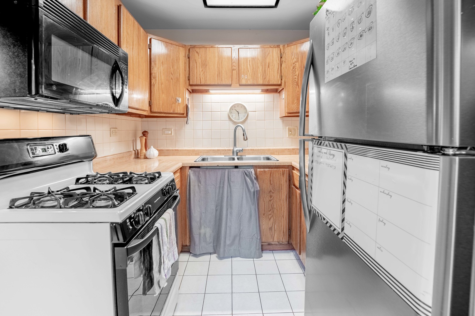 3632 Harlem Avenue Riverside, IL 60546 - Photo 10 of 26 a kitchen with white cabinets and appliances