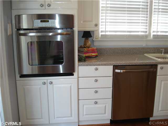 4025 Poplar Grove Road Midlothian, VA 23112 - Photo 6 of 12 a kitchen with stainless steel appliances white cabinets and a microwave oven