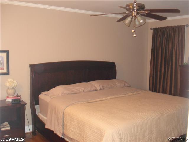 4025 Poplar Grove Road Midlothian, VA 23112 - Photo 8 of 12 a bedroom with a bed and a chandelier