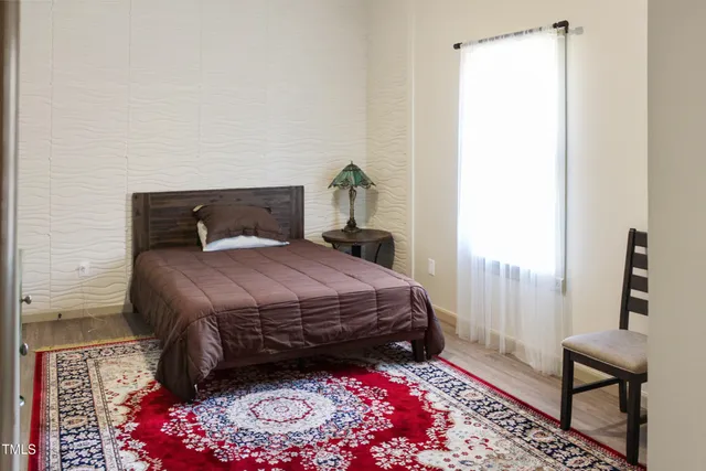 a bedroom with a bed and a window