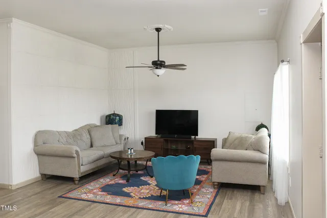 a living room with furniture and a flat screen tv