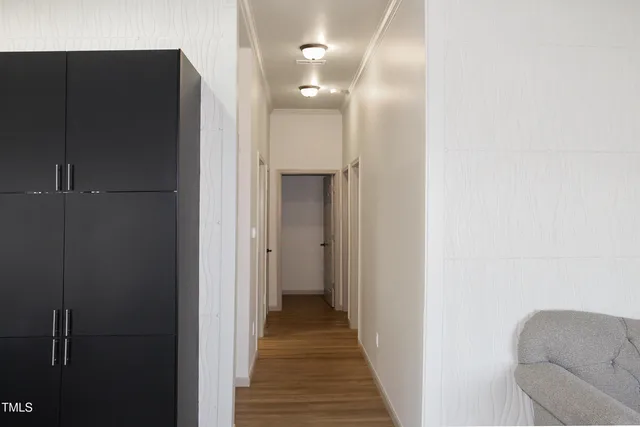 a view of a hallway with wooden floor