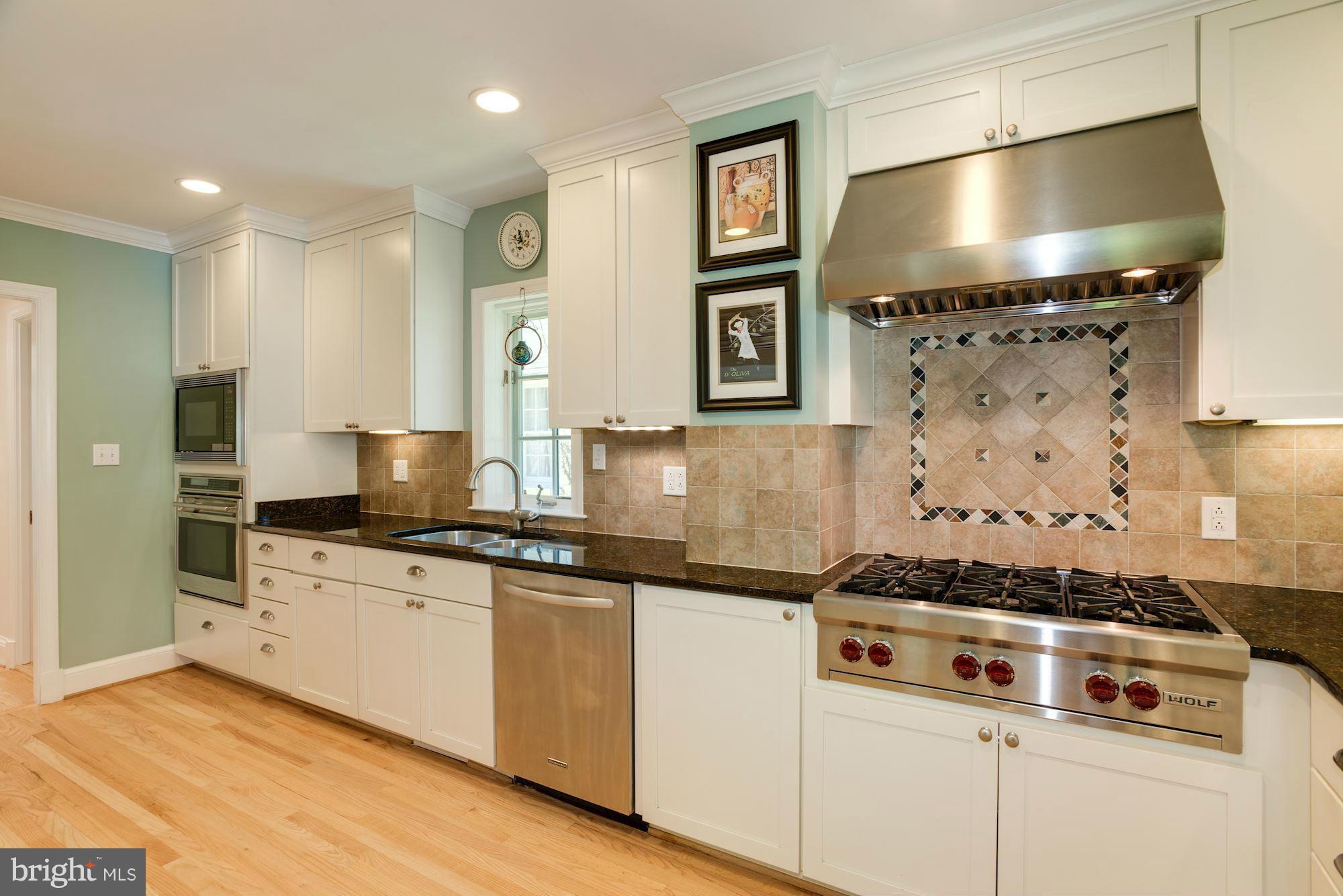 6224 30th Street Northwest Washington, DC 20015 - Photo 10 of 30 a kitchen with stainless steel appliances a stove and a refrigerator