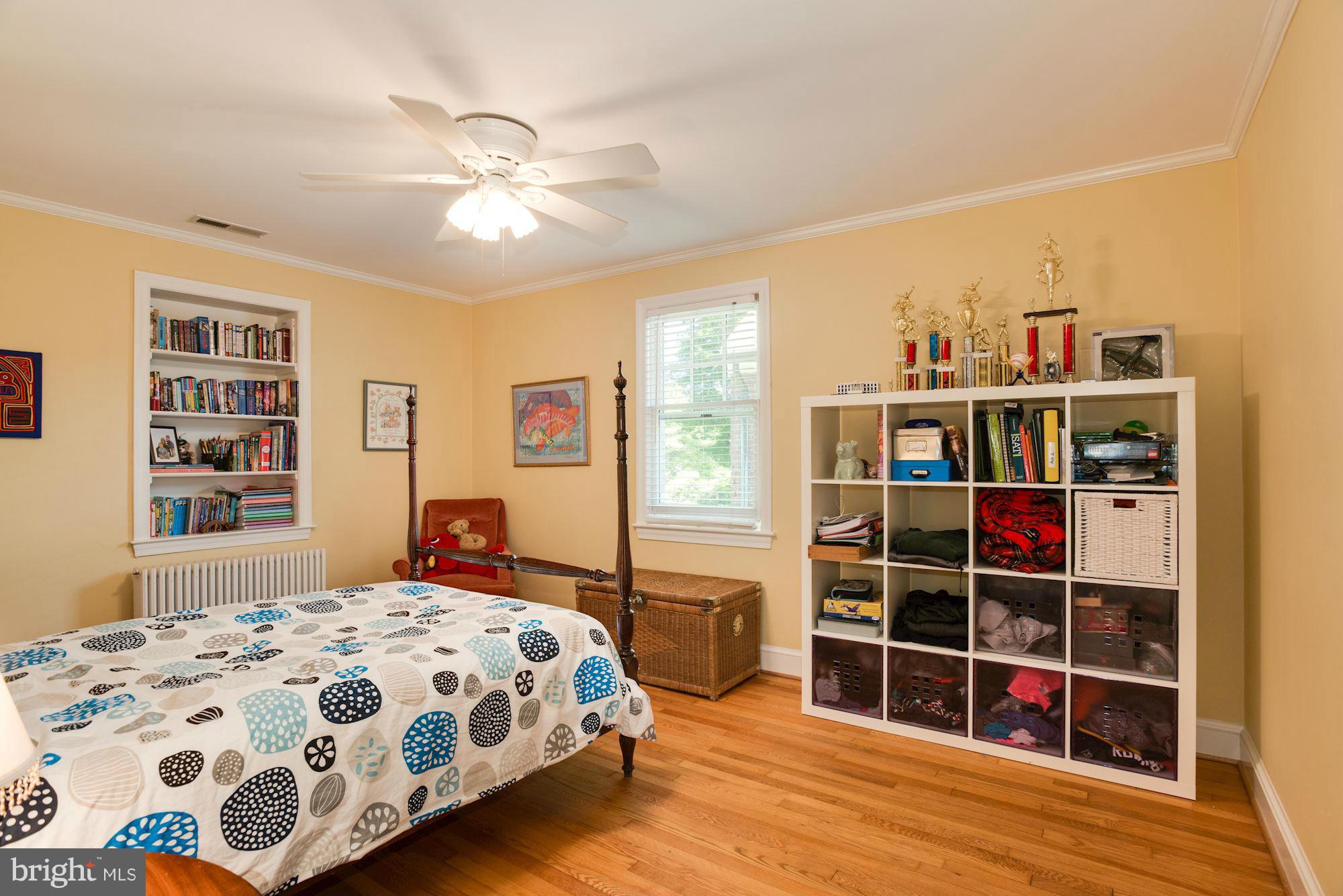 6224 30th Street Northwest Washington, DC 20015 - Photo 19 of 30 a bedroom with a bed cabinets and window