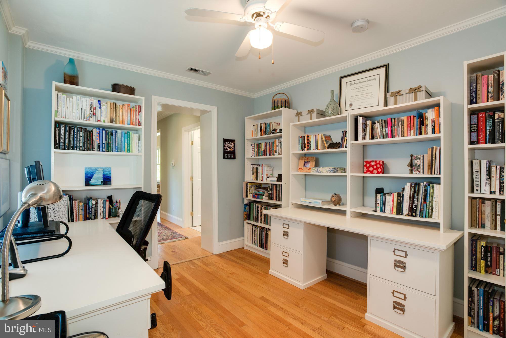 6224 30th Street Northwest Washington, DC 20015 - Photo 21 of 30 a view of a workspace with furniture and a book shelf