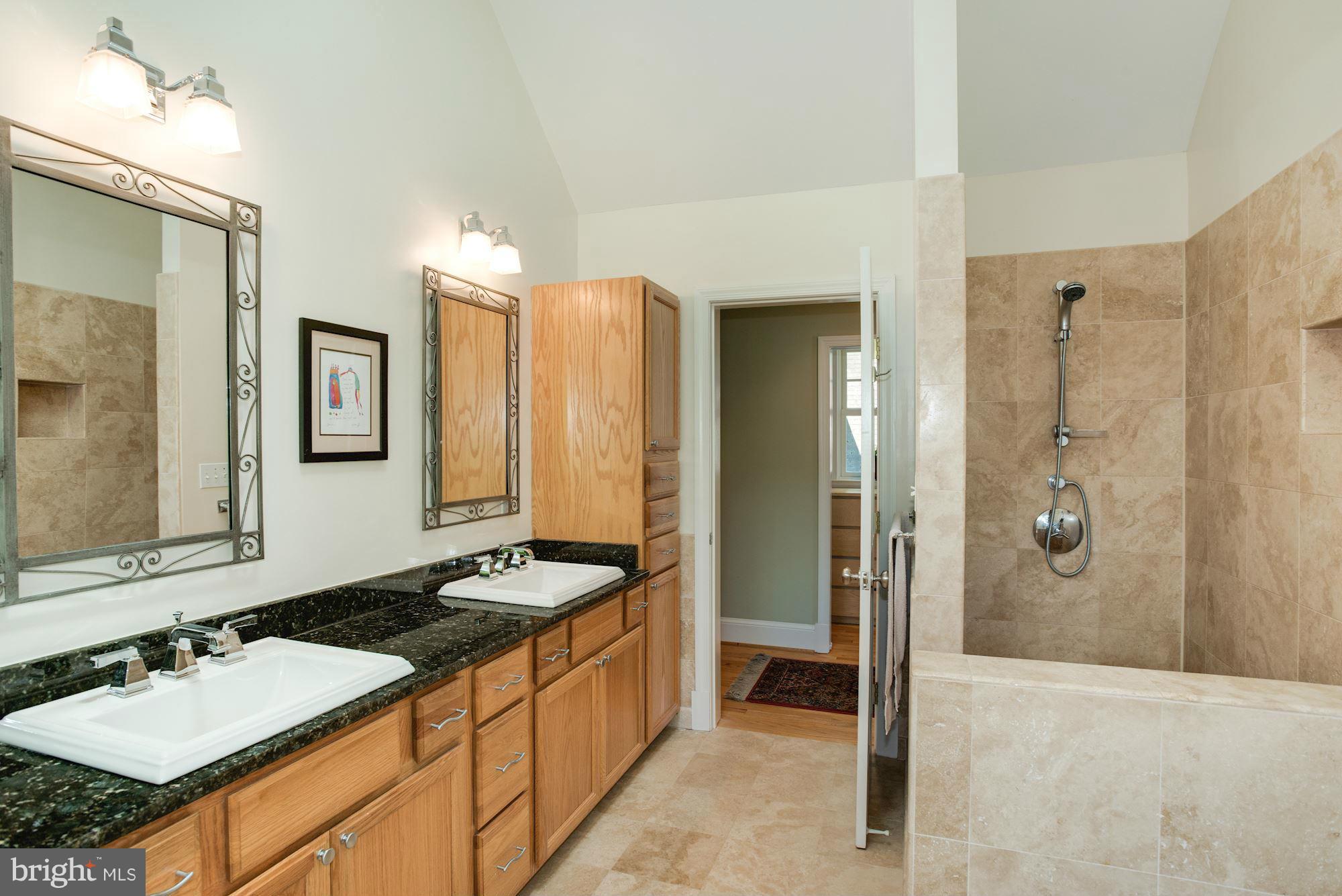 6224 30th Street Northwest Washington, DC 20015 - Photo 23 of 30 a bathroom with a granite countertop sink and a mirror