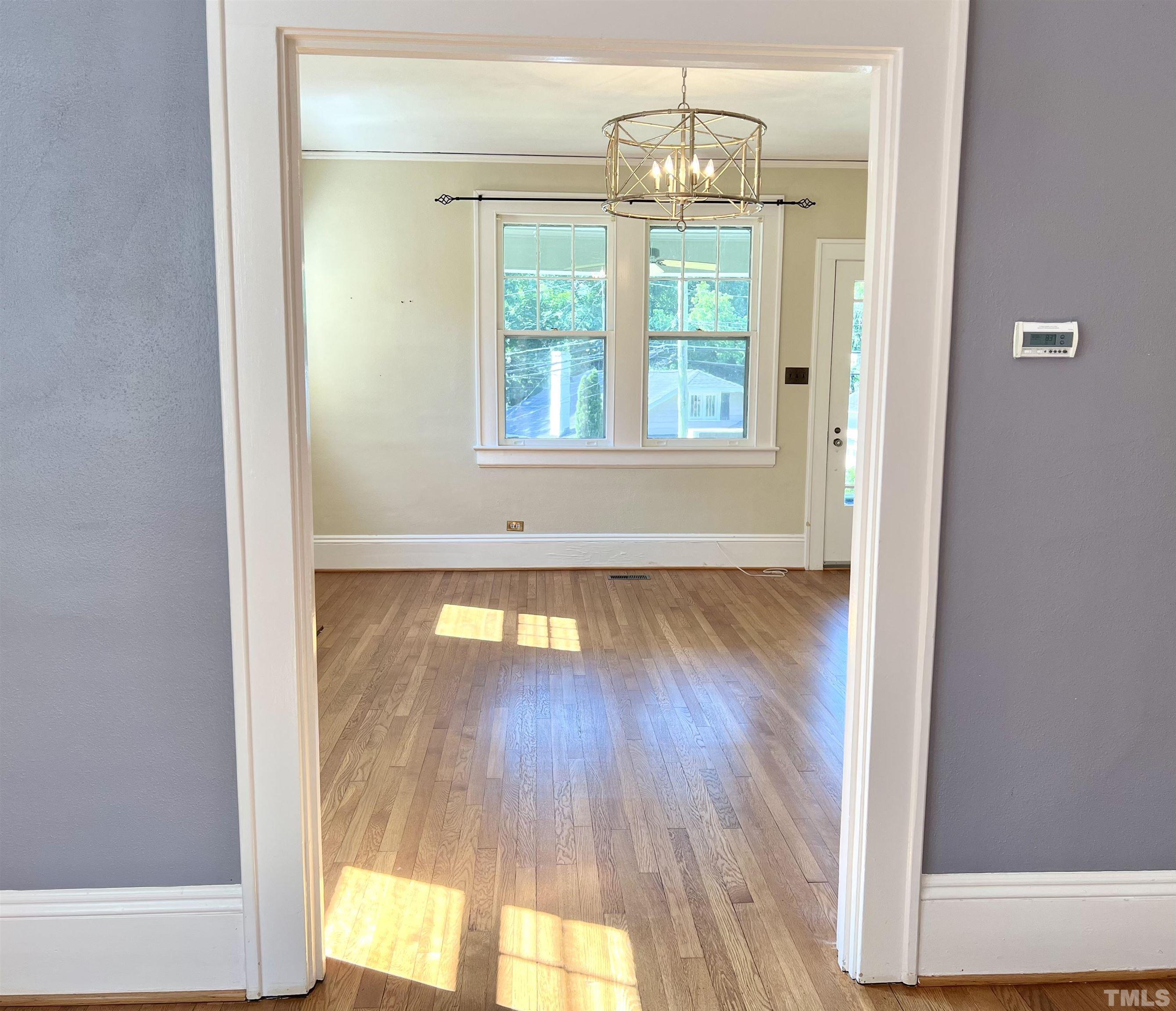1925 Alexander Road Raleigh, NC 27608 - Photo 14 of 42 a view of empty room with wooden floor and fan