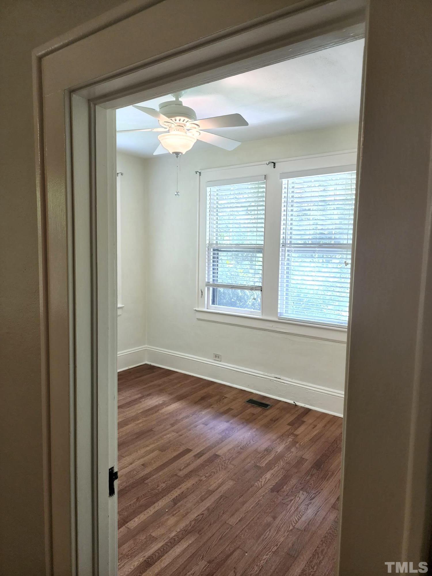 1925 Alexander Road Raleigh, NC 27608 - Photo 27 of 42 a view of an empty room with wooden floor and a window