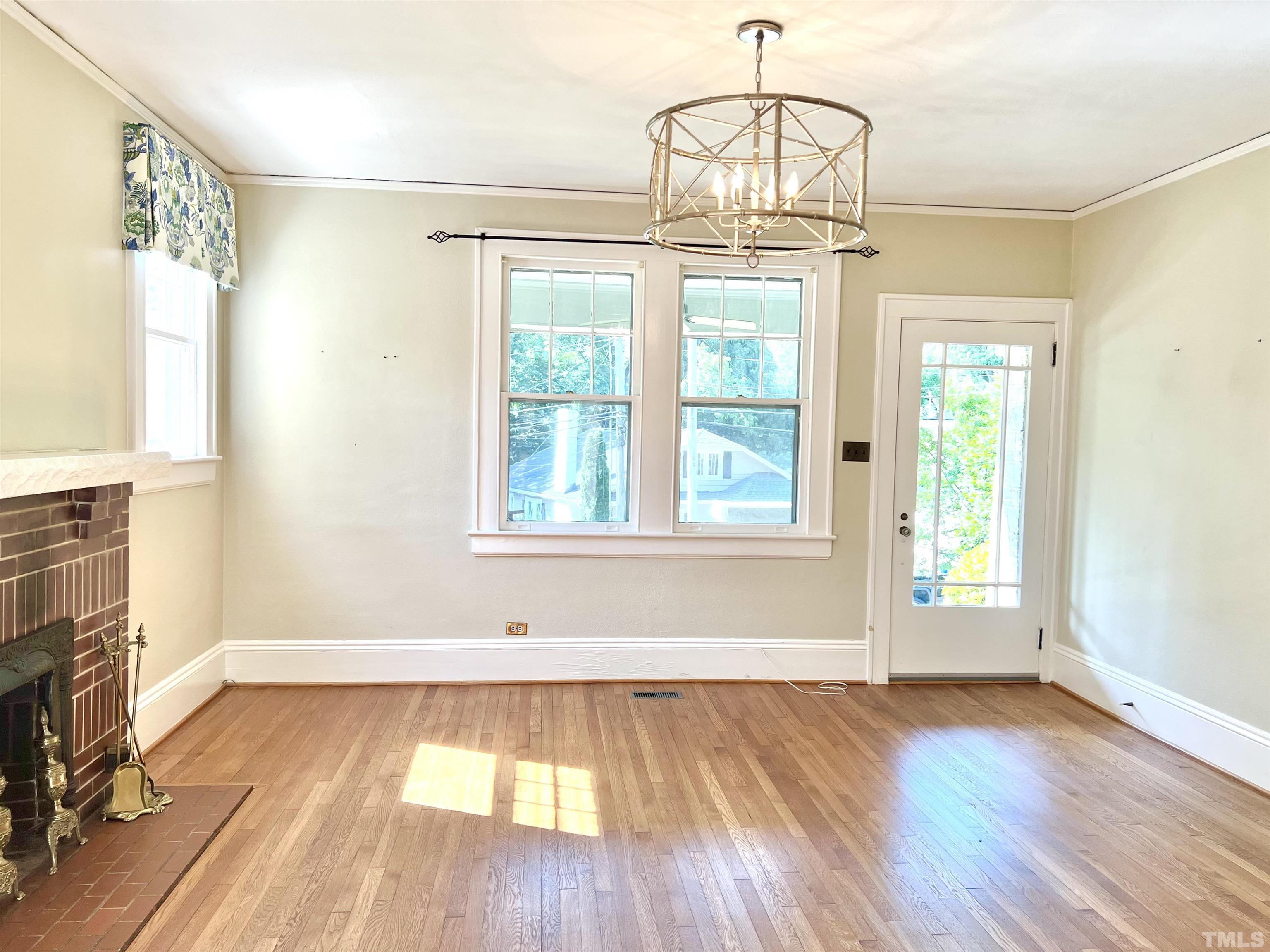 1925 Alexander Road Raleigh, NC 27608 - Photo 9 of 42 a view of empty room with wooden floor and fan