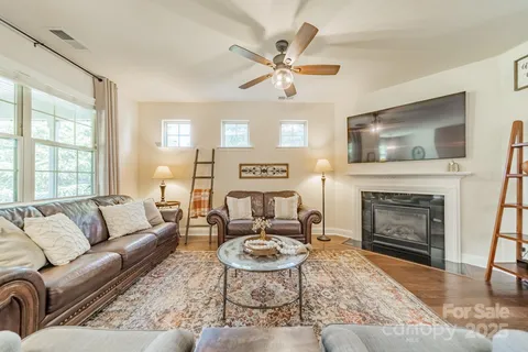 a living room with furniture a window and a fireplace