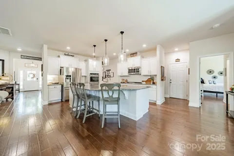 a view of a dining area kitchen with furniture and wooden floor