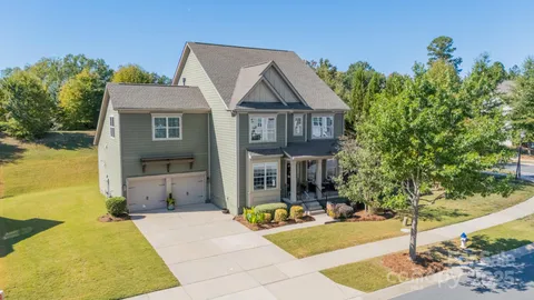 a view of house with outdoor space and swimming pool