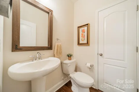 a bathroom with a toilet a sink and a mirror