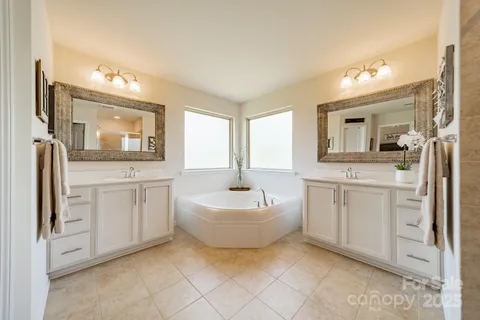 a spacious bathroom with a toilet sink and mirror