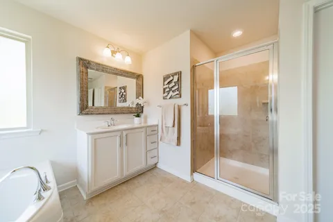 a bathroom with a granite countertop sink mirror and shower
