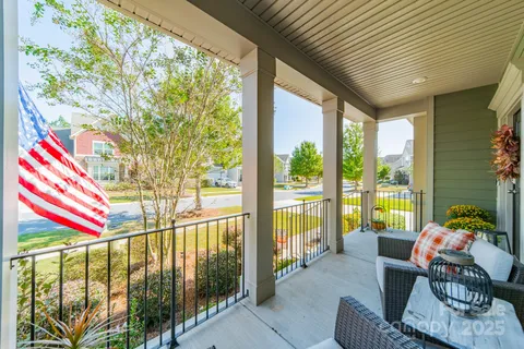 a living room filled with furniture and floor to ceiling windows