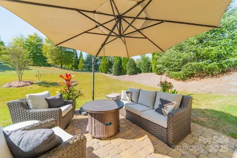 a outdoor living space with furniture and umbrella