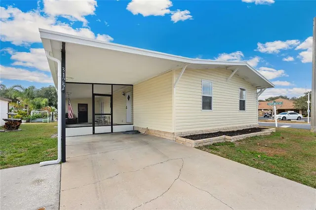 a view of a house with a backyard