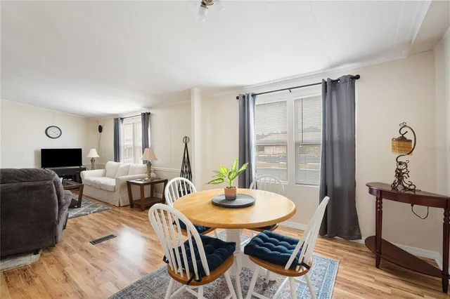a dining room with furniture and window