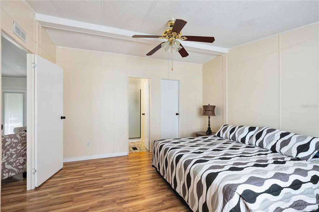 3125 Briar Street Wesley Chapel, FL 33543 - Photo 15 of 42 a bedroom with a bed and a chandelier