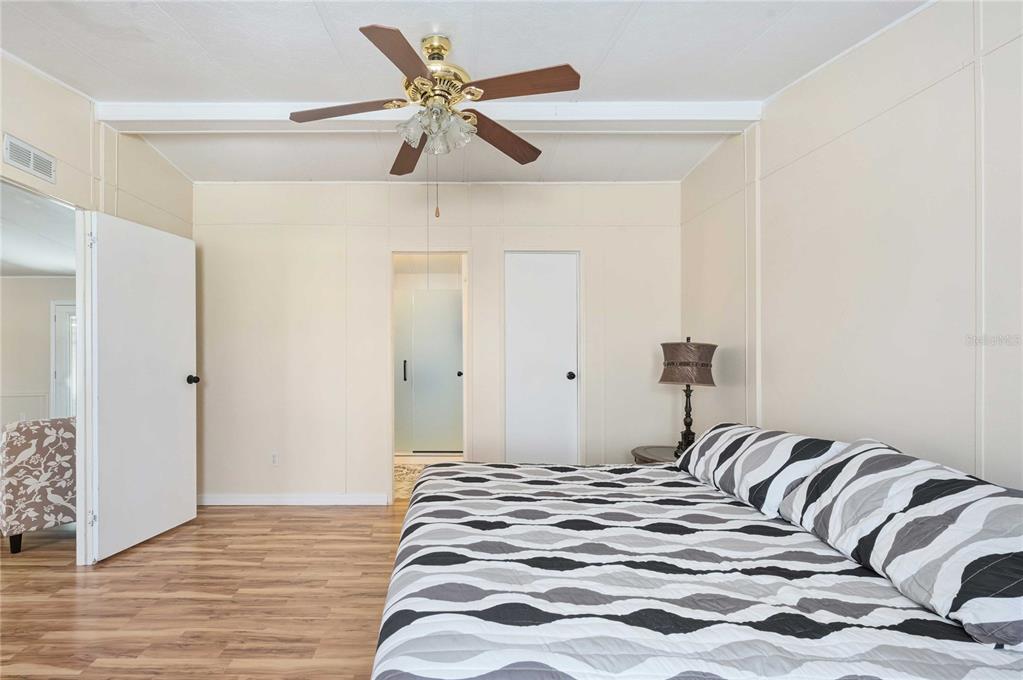 3125 Briar Street Wesley Chapel, FL 33543 - Photo 16 of 42 a bedroom with a bed and a chandelier