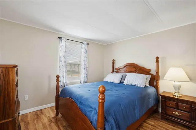 a bedroom with bed and a night stand