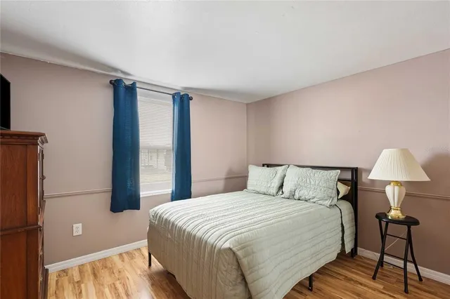 a bedroom with a bed and a lamp