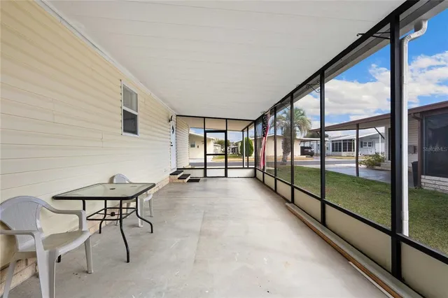 a view of a room with furniture and floor to ceiling window